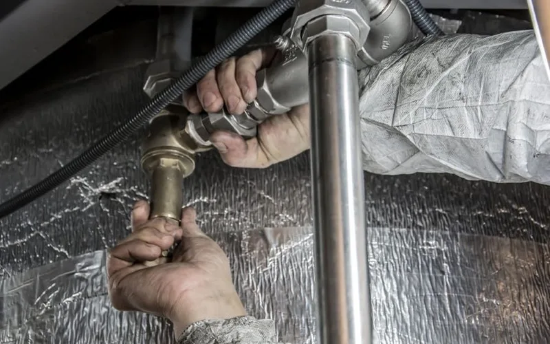 Repairing pipework under a sink during an emergency callout